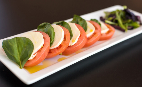 Enjoy a Caprese salad at 308 Lakeside that includes layered beefsteak tomato with fresh mozzarella cheese, basil, and drizzled with extra virgin olive oil