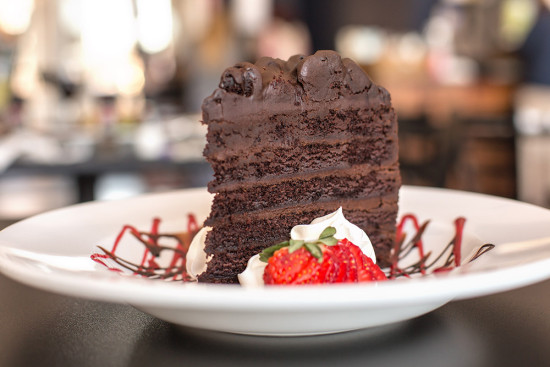 Finish off your meal at 308 Lakeside with a piece of chocolate cake drizzled with chocolate and strawberry sauce
