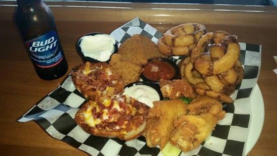 Indulge in the 308 Platter appetizer that consists of Jumbo Chicken Wings, Cheese Wedges, Potato Skins, and Black & Tan Onion Rings