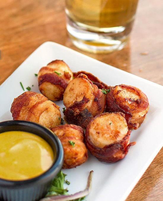 For an appetizer, enjoy the spicy scallops that are wrapped in jalapeno bacon and served with honey mustard sauce