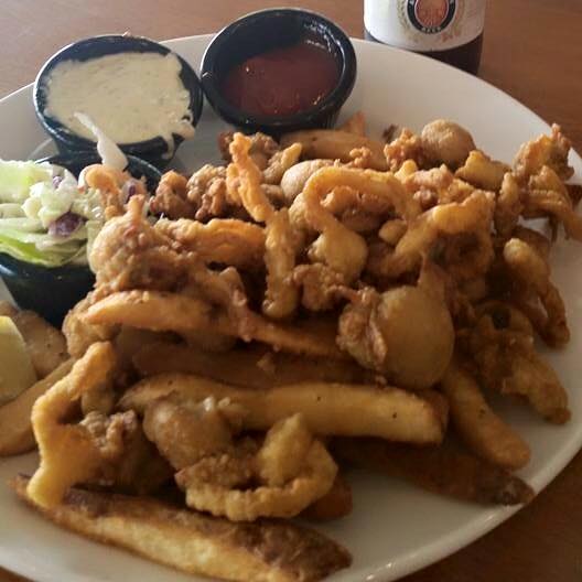 Enjoy fried clams, french fries and cole slaw with a drink at 308 Lakeside